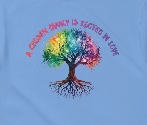 A Carolina Blue t-shirt featuring a colorful graphic of a tree with a rainbow-colored canopy and roots, with the text 'A Chosen Family is Rooted in Love' arched above it in pink and purple lettering.