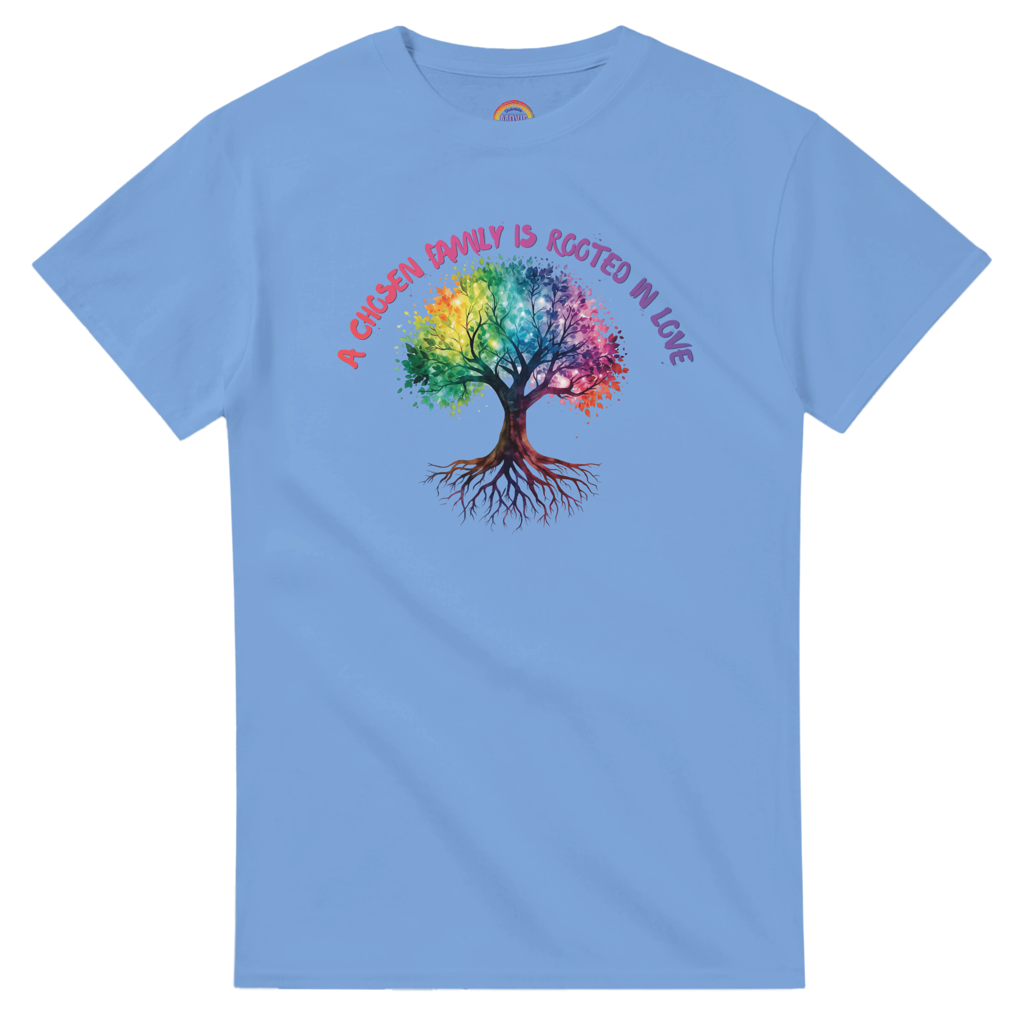 A Carolina Blue t-shirt featuring a colorful graphic of a tree with a rainbow-colored canopy and roots, with the text 'A Chosen Family is Rooted in Love' arched above it in pink and purple lettering.