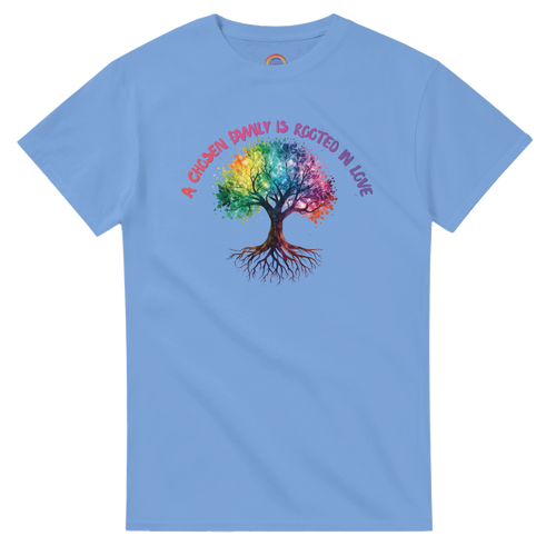 A Carolina Blue t-shirt featuring a colorful graphic of a tree with a rainbow-colored canopy and roots, with the text 'A Chosen Family is Rooted in Love' arched above it in pink and purple lettering.