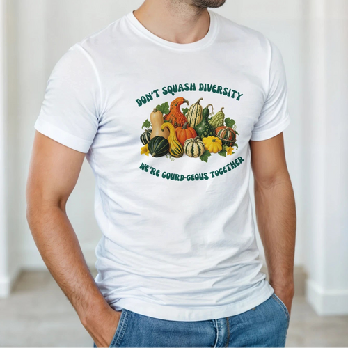 A model wearing a white tee shirt with a Don't Squash Diversity featuring an assortment of colorful gourds.  Under the image: We're Gourd-geous together