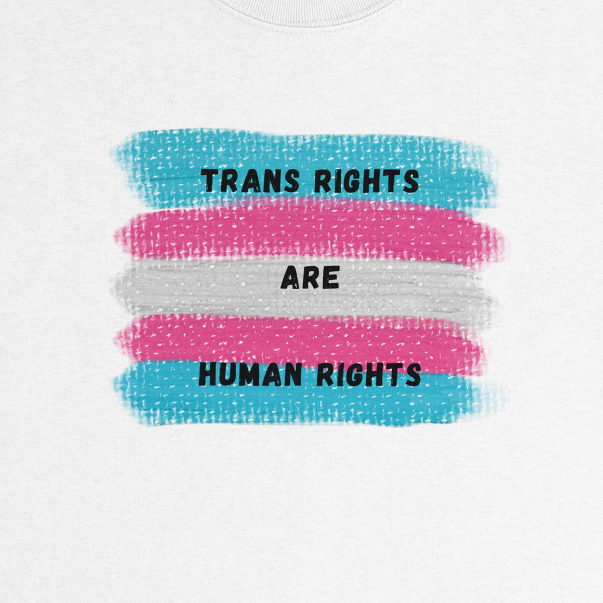 A close-up of a white t-shirt featuring a printed graphic of the transgender pride flag with the text 'TRANS RIGHTS ARE HUMAN RIGHTS' in black capital letters. The back ground is swatches showing trans flag colors.