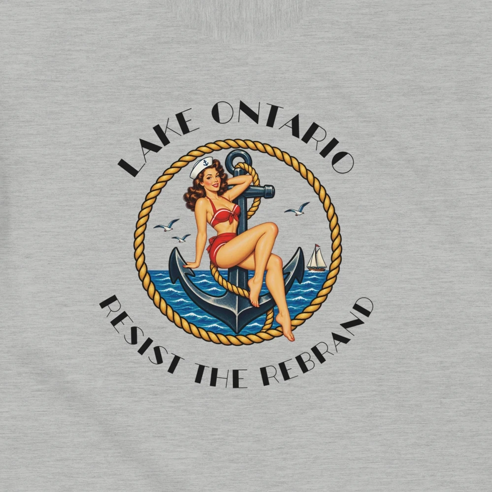 A light heather gray short-sleeve t-shirt with a vintage-style circular graphic on the chest. The graphic features a pin-up illustration of a woman in a red bikini  seated on a blue anchor, with the text 'LAKE ONTARIO' above and 'Resist the Rebrand' below in black.